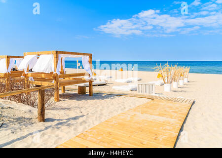 Pathway to sandy beach with sun beds in Jurata village on Hel peninsula, Baltic Sea, Poland Stock Photo