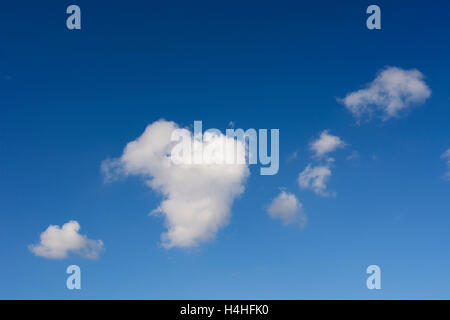 Heart shaped cloud against a deep blue sky. Stock Photo
