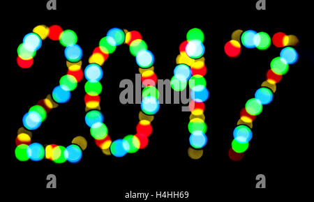 Happy New Year 2017 written blurred lights on a black background Stock Photo