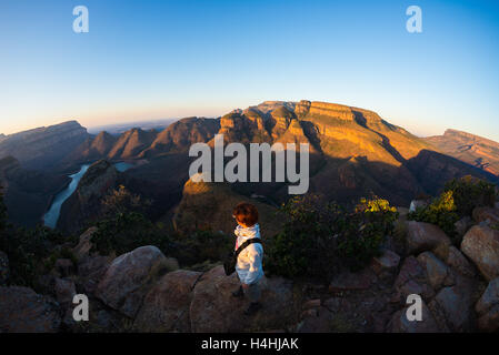 Blyde River Canyon, famous travel destination in South Africa. Tourist looking at panorama at sunset. Last sunlight on the mount Stock Photo