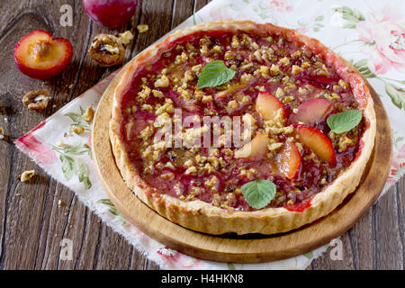 Plum cake shortbread dough with walnuts on a wooden table, selective focus. Stock Photo