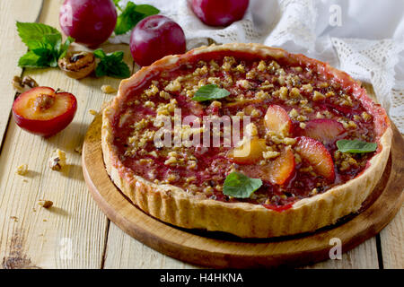 Plum cake shortbread dough with walnuts on a table in a rustic style. Stock Photo