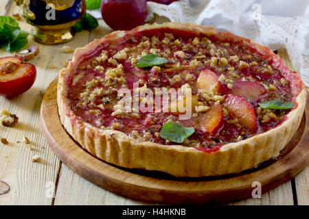 Plum cake shortbread dough with walnuts on a table in a rustic style. Stock Photo