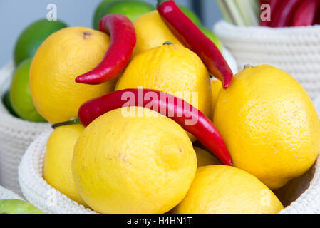 the lemons and chili peppers in a wicker basket close-up Stock Photo