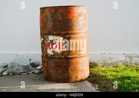 An old rusty oil barrel in the sunlight Stock Photo