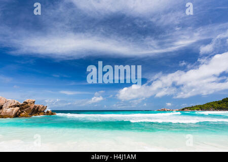 Perfect tropical beach Anse Cocos in La Digue, Seychelles with granite boulders and palm trees Stock Photo