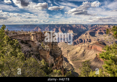 Tourists looking at  skyline scenery of Grand Canyon National Park from point of view named 'Mather Point'. Stock Photo