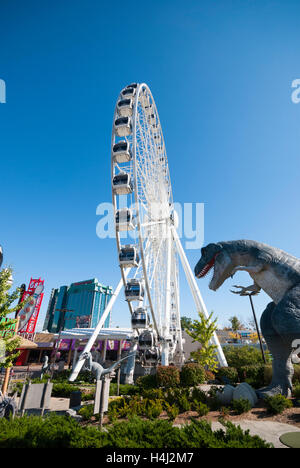 The Skywheel seen next to Dinosaur Adventure Golf a 70,000 sq foot dinosaur themed mini golf attraction in Niagara Falls Canada Stock Photo