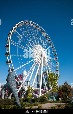 The Skywheel seen next to Dinosaur Adventure Golf a 70,000 sq foot dinosaur themed mini golf attraction in Niagara Falls Canada Stock Photo