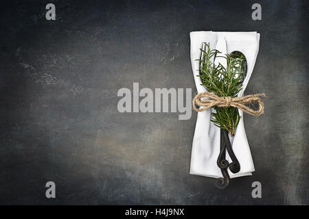 Antique silverware spoon and fork over a rustic grunge background. Image shot from overhead. Stock Photo