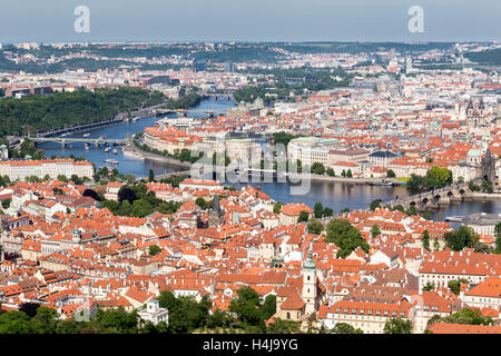 View of the River Vltava, bridges including Charles Bridge (Karlûv Most), and the city rooftops of Prague. Stock Photo