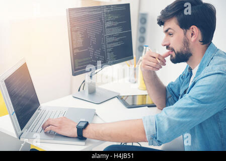 Young man working as a programmer Stock Photo