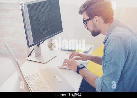 Enthusiastic programmer doing his work Stock Photo