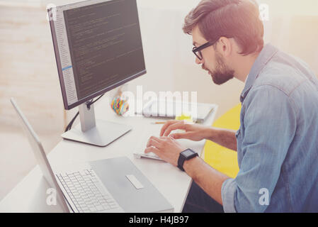 Concentrated programmer coding in an office Stock Photo