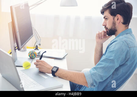 Hardworking programmer concentrating on his work Stock Photo