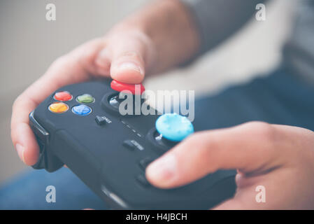 Man playing and holding joystick Stock Photo