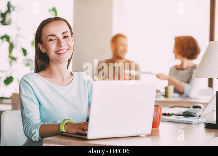 Nice smiling  woman using laptop Stock Photo