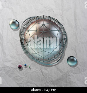 large steel sphere with a glossy color reflections in the iron lattice and small glass spheres on a light background of crumpled Stock Photo
