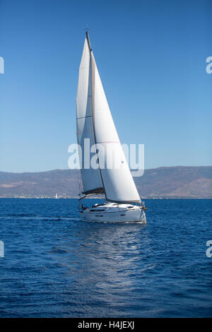 Luxury yacht with color sails at Regatta. Sailing in the wind through ...