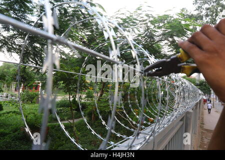 Being secured with razor wire on top of the iron fence in the capital ...