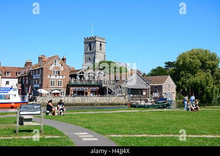 Boats on the river with views towards The Old Granary and Lady St Mary church, Wareham, Dorset, England, UK, Western Europe. Stock Photo