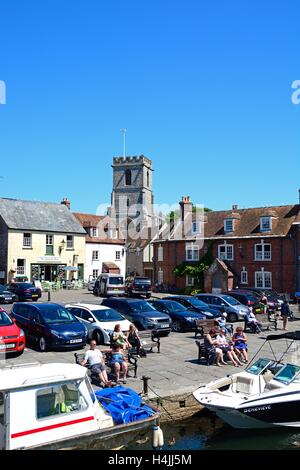 Boats moored on the river with views towards The Old Granary and Lady St Mary church, Wareham, Dorset, England, UK, Europe. Stock Photo