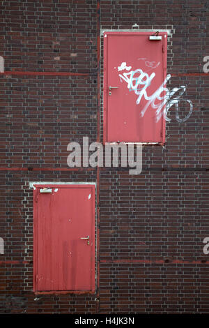 Steel doors in the wall of an industrial facade, Ruhrgebiet region, North Rhine-Westphalia Stock Photo