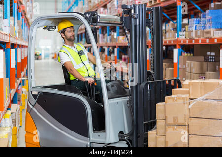 Male worker using forklift Stock Photo