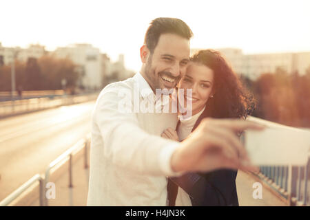 Couple in love taking selfies outdoors Stock Photo