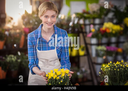 Female florist touching flower bouquet Stock Photo