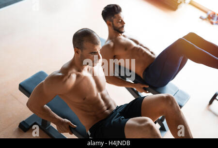 Two guys working out in gym Stock Photo - Alamy