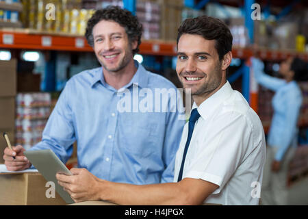 Portrait of warehouse workers using digital tablet Stock Photo