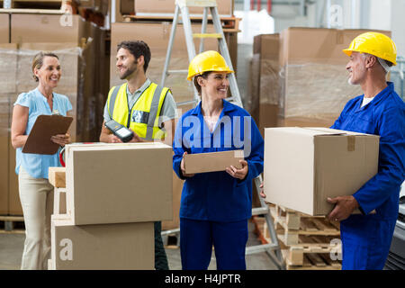 Warehouse worker interacting with each other Stock Photo