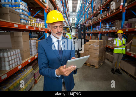 Warehouse manager using digital tablet Stock Photo