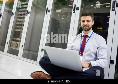 Technician using laptop Stock Photo