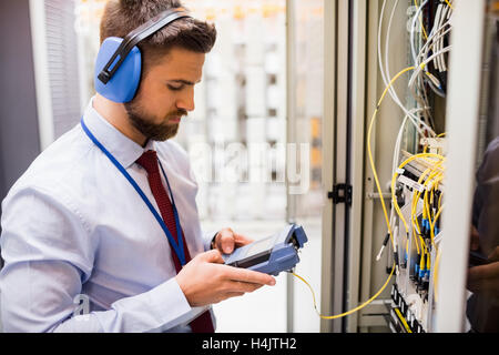 Technician using digital cable analyzer Stock Photo