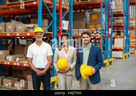 Portrait of warehouse managers and worker standing together Stock Photo