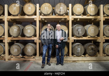 Owen, Germany. 13th Oct, 2016. Christian Gruel (r) and his grandson Immanuel Gruel stand in front of whisky barrels in the whisky barrel cellar of spirits distillery Gruel in Owen, Germany, 13 October 2016. PHOTO: MARIJAN MURAT/dpa/Alamy Live News Stock Photo