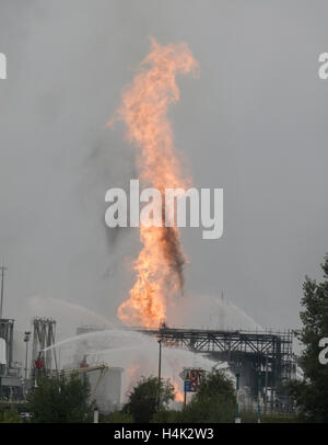 Ludwigshafen, Germany. 17th Oct, 2016. Flames rise over the premises of the chemical company BASF in Ludwigshafen, Germany, 17 October 2016. Numerous people went missing after a huge explosion on the company grounds and several are injured, according to city and company. Photo: Frank Rumpenhorst/dpa/Alamy Live News Stock Photo