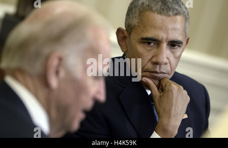 Washington, District of Columbia, USA. 17th Oct, 2016. United States Vice President Joe Biden speaks as US President Barack Obama looks on while discussing the release of the Cancer Moonshot Report in the Oval Office of the White House on October 17, 2016 in Washington, DC. Credit: Olivier Douliery/Pool via CNP Credit:  Olivier Douliery/CNP/ZUMA Wire/Alamy Live News Stock Photo