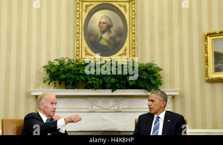 Washington, DC. 17th Oct, 2016. United States Vice President Joe Biden speaks as US President Barack Obama looks on while discussing the release of the Cancer Moonshot Report in the Oval Office of the White House on October 17, 2016 in Washington, DC. Credit: Olivier Douliery/Pool via CNP - NO WIRE SERVICE - © dpa/Alamy Live News Stock Photo