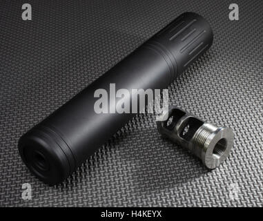 Suppressor and the adapter that holds it on the barrel of a rifle Stock ...