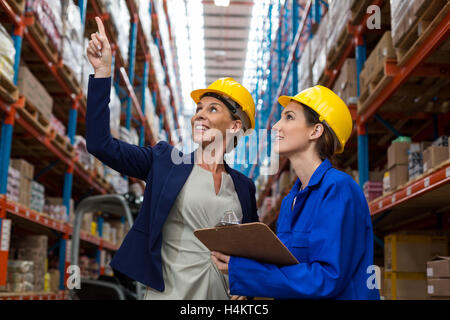 Warehouse manager and worker checking the inventory Stock Photo