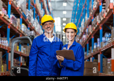 Warehouse workers standing together in warehouse Stock Photo