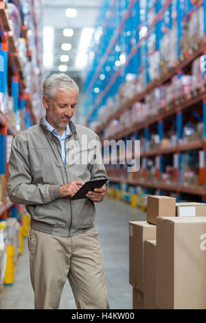 Warehouse manager using digital tablet Stock Photo