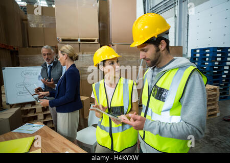 Warehouse workers and managers interacting with each other Stock Photo