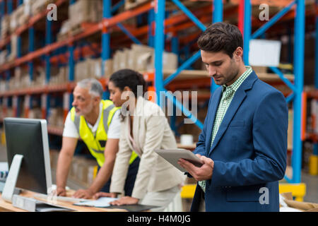Warehouse managers and worker working together Stock Photo