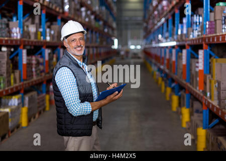 Portrait of warehouse worker checking the inventory Stock Photo