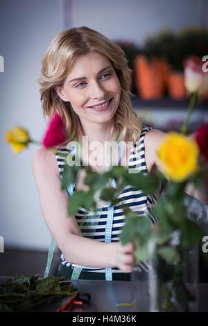 Female florist arranging flower Stock Photo