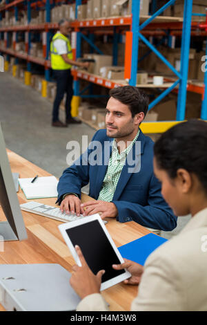 Warehouse managers working together Stock Photo